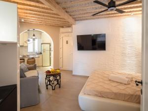 a living room with a couch and a ceiling fan at Arcadia by Kallisto Royal Suites in Ornos