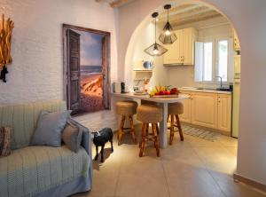 a kitchen with a couch and a table in a room at Arcadia by Kallisto Royal Suites in Ornos