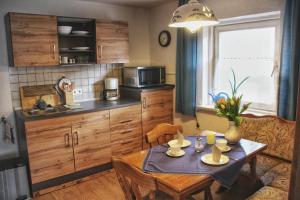 a kitchen with a table and a small kitchen with a table and chairs at Ferienwohnung Karwendelblick in Mittenwald