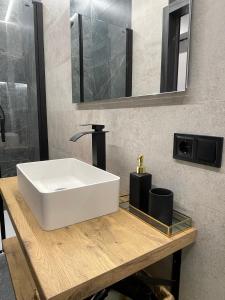 a bathroom with a white sink and a mirror at Plaza Mayor de Salamanca By LixLoft in Salamanca