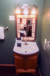 a bathroom with a sink and a mirror at Timber Creek Chalets- 6 chalet in Estes Park