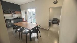 a kitchen with a wooden table and chairs in a room at Hostel Mirandopólis in São Paulo +32 photos