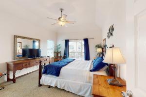 a bedroom with a bed and a mirror and a television at Sea Breeze in Galveston