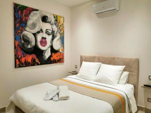 a bedroom with two beds and a painting of a woman at Entre mer et campagne in Saint-Martin-de-Seignanx