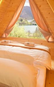 a bedroom with a bed and a window with a view at Cottages Relax in Jajce