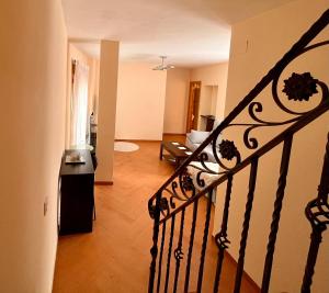 a room with a staircase and a living room at APARTAMENTOS TURíSTICOS MONTASOL 2 in Montánchez
