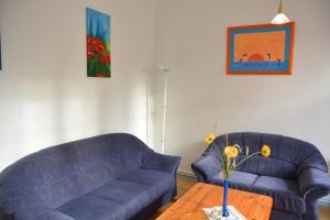 a living room with a blue couch and a wooden table at 4 Plau in Borkow