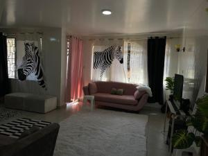 a living room with two zebra heads on the wall at Villa Quartet Retreat in Nairobi