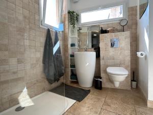 a bathroom with a toilet and a sink and a window at La glycine in Saint-Marc-Jaumegarde +102 photos