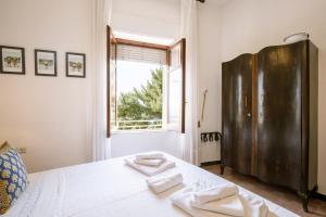 Postel nebo postele na pokoji v ubytování Giaminera Rooms & Art Studio
