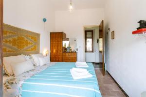 Postel nebo postele na pokoji v ubytování Giaminera Rooms & Art Studio