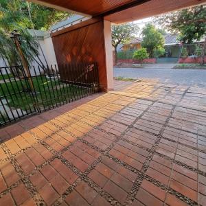 a brick patio with a fence on it at Hotel Palermo in Santa Cruz de la Sierra