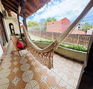 a hammock on a porch with a view of a building at Hotel Palermo in Santa Cruz de la Sierra