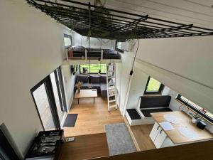 a tiny house with a living room and a loft at *NEU* Tiny-House am Humboldtsee in Salzhemmendorf