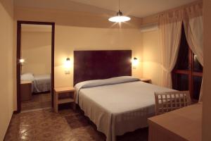 Postel nebo postele na pokoji v ubytování Hotel Grotticelle