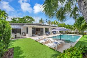 una foto di una villa con piscina di Coastal Style Haven Beach Proximity Heated Pool Tranquility Manatee Ranch Key RESlDENCES a Fort Lauderdale