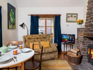 a living room with a couch and a table at 1 bed in Llangynidr BN079 in Llangynidr