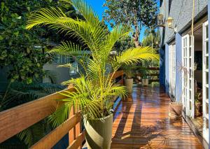 a porch with potted plants on the side of a house at Otima casa com lazer completo em Sao Conrado RJ in Rio de Janeiro