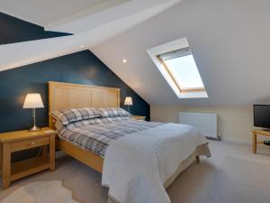 a bedroom with a large bed and a skylight at 3 Bed in Spittal CN168 in Spittal