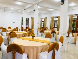 a banquet hall with tables and chairs in a room at Carmel Hill Resort in Ambagamuwa