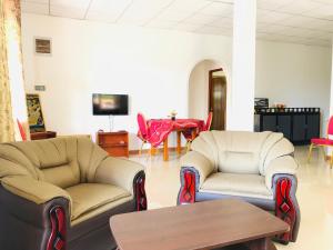 a living room with two chairs and a table at Carmel Hill Resort in Ambagamuwa