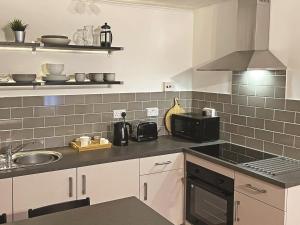 a kitchen with a sink and a stove at 1 Bed in Tenby 89847 in Penally
