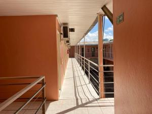 an empty hallway of a building with a balcony at Pousada Caliente in Maceió