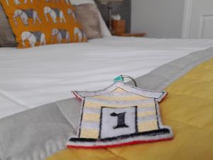 a blanket with a house on it on a bed at The Briarfields in Torquay