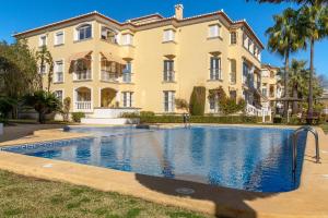 a large house with a swimming pool in front of it at Casita Bonita - with private garden near beach in Jávea in Jávea