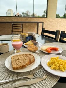 una mesa con platos de desayuno. en Hotel Pigalle, próximo a Expo São Paulo, en São Paulo