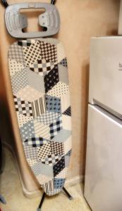 a tie hanging on a wall next to a refrigerator at A 2 pas de la plage, appartement cosy, confort, proche toutes commodités, Wifi haut débit, TV connectée, Netflix, climatiseur, Acte mariage pour couple national,3 nuits mimum in El Jadida