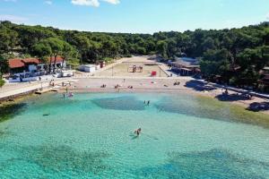 an aerial view of a beach with people in the water at Mobile home - EXCLUSIVE in Biograd na Moru