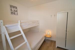 a bedroom with a bunk bed with a ladder at Berg-Juwel mit Pool und Sauna für Familien und Hunde ideal in Missen-Wilhams
