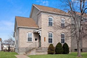 a brown brick house with a brown roof at Modern Escape: 5BR/2.5BA Near St. Louis Must-Sees in Saint Louis