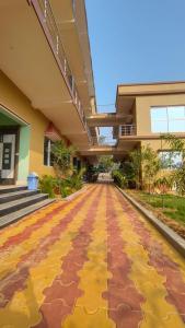 an empty hallway of a building with a yellow sidewalk at Saikat Saranya Resort, #Mandarmoni #Beach in Mandarmoni