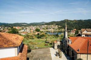 a view of a town with a river and a church at Hotel Restaurante GBC Isape in Arcade