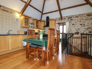 a kitchen with a table and chairs in a room at Sunnywell in Bodmin