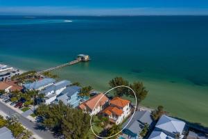 an aerial view of a beach with houses and a dock at Dolphins Run home in Anna Maria