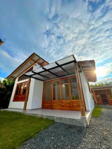 a small house with wooden doors and a sky at Eco Cabañas Montana - Glamping 2 