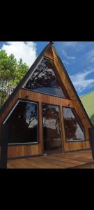 a house with a gambrel roof with three windows at ECO PARK ALTA MIRA in São Francisco de Paula