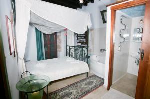 a bathroom with a tub and a sink and a bath tub at Ifigenia Rooms in Chania