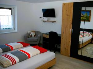 a bedroom with two beds and a desk and a window at Sellraintaler Auszeit 1 in Sellrain