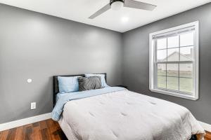 a bedroom with a bed with a ceiling fan at Bowling Green Duplex Rental about 5 Mi to Downtown! in Bowling Green