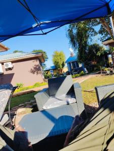 a person laying in a chair under an umbrella at Bukari Executive Lodge in Mpongwe