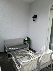 a patio with two chairs and a table and a lamp at Charmante Ferienwohnung Limburg in Limburg an der Lahn +14 photos