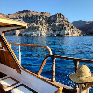 a hat sitting on a boat on the water at Mondragón in Puerto de Mogán