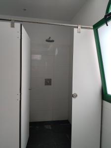 a bathroom with a shower with white walls at Mondragón in Puerto de Mogán