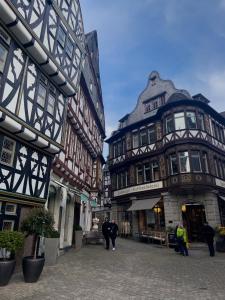 a group of people walking down a street with buildings at Charmante Ferienwohnung Limburg in Limburg an der Lahn