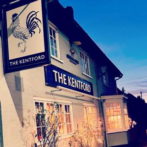 a building with a sign for a restaurant with a chicken on it at Captivating 1-Bed Apartment in Newmarket in Kentford