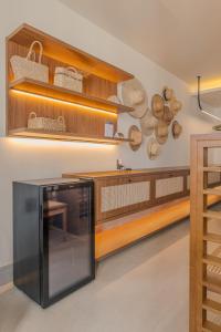 a kitchen with wooden shelves and a counter with pots and pans at Gorges Residence Salvador in Salvador